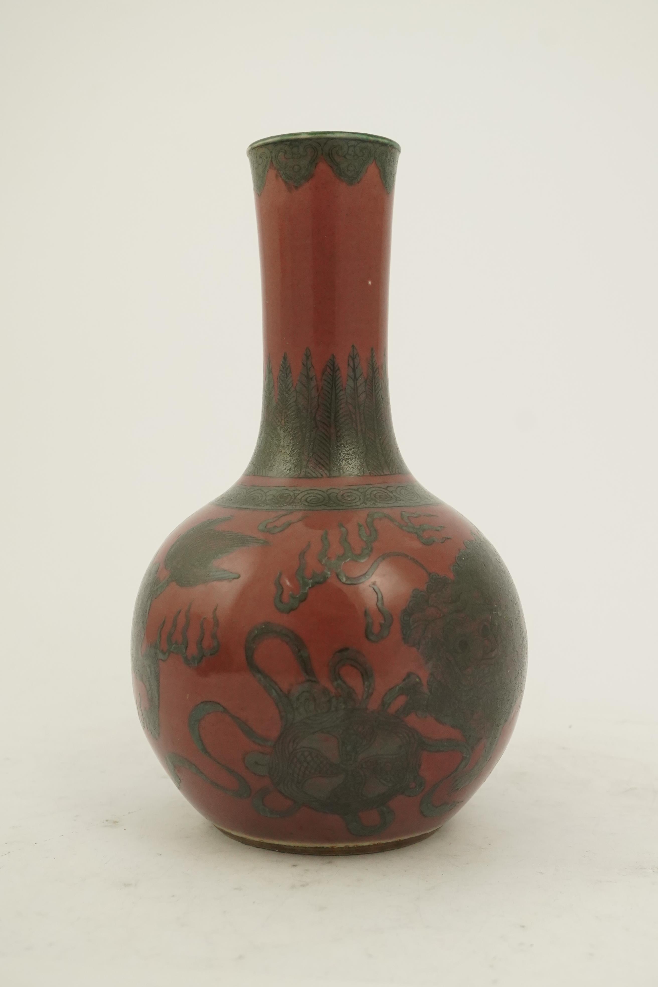 A Chinese green enamelled sang de boeuf ground 'lion' bottle vase, probably 18th century